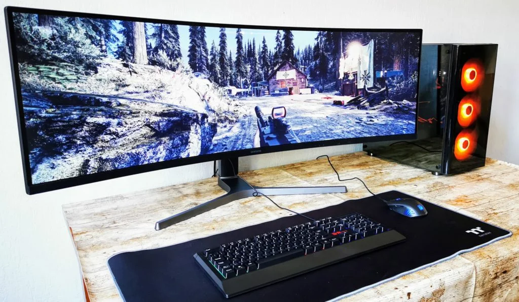 Samsung C49RG90 in use - Level Up: Essential Gadgets for Your Ultimate Gaming Setup